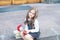 First day of school. Back to school. Child girl schoolgirl elementary school student sits on the steps near the school and holds a