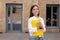 First day at work. Cheerful girl with a folder, portrait of a student