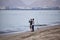 On the first evening of lockdown being lifted, two men wearing face masks set up their fishing gears on the beach in the evening