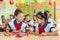 First-form schoolchildren in classroom at school desks on holiday of beginning of elementary school education. Happy girls at