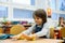 First grade boy at school, preparing hand made items for Christm