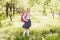 First-grader girl stands with a school pink backpack outdoors