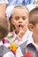 First grader on the line of first of September thinking stuck a finger in his mouth