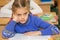 First grader to read lesson and looking at teacher listens carefully to his