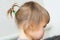 First hair style: tiny ponytail, profile of baby girl