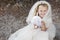 First holy communion girl with dress, veil and candle