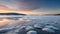 First light of dawn reflecting off a frozen lake