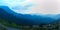 First light of day and the woman breathe fresh air , watching  sunshine and mist on top of the mountain.  Mountain with The fog