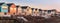 First light on row of colourful beach houses