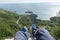 First person perspective sightseeing of sveti stefan in Budva, Montenegro. Legs with blue sneakers of a traveler in a cliff with