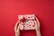 First person top view photo of saint valentine`s day decor sequins female hands taking giftbox in white wrapping paper with heart