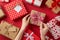 First person top view photo of st valentine`s day decorations presents and woman`s hands untying checkered ribbon bow on kraft
