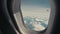 First-person view. Aircraft in the sky. Clouds outside the window or porthole of an airplane.