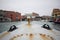 First person view of ancient rusty metal boat with old italian venice city and river scape cloudy Sky