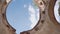 First-person view. Man walks in abandoned building. Round hole is spinning.