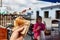 First person view shot of a man and a girl eating hamburger in the street cafe, soft focus, shallow depth of field.