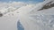 First-person view snowboarder on snowboard running down the slope in Ski resort. Winter sport and recreation, leisure