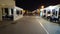 First person view walking at night on the quay of marina at coastal district in Ostia Lido, restaurant with waitress serving at t