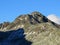 First snow on the rocky mountain peak Piz Champatsch (2946 m) in the Swiss Alps and above the mountain road pass Fluela