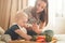 First solid food for young kid. Fresh organic carrot for vegetable lunch. Baby weaning.