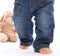 First steps - little baby feets in Jeans isolated on white with