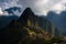 First sunlight on Machu Picchu from opening clouds