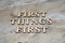 First things first , writen wooden letters on stone background