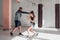 The first training of a novice girl fighter in kickboxing, the coach shows the blows