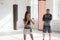 The first training of a novice girl fighter in kickboxing, the coach shows the blows