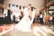 First wedding dance of newlywed couple in restaurant