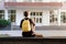 First year student sitting outside a university or school facility. Freshman waiting for the beginning of the classes