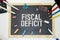 FISCAL DEFICIT text on white paper. notebook sheets