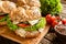 Fish burger with mackerel meat, cheese and fresh vegetable