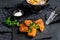 Fish and chips, French fries and cod fillet fried in breadcrumbs. Black background. Top view