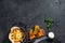 Fish and chips, French fries and cod fillet fried in breadcrumbs. Black background. Top view. Copy space