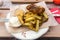 Fish and chips served with curry and tartar sauce