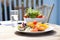 fish and chips served with a side salad on a sunny patio