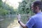 Fish chub on a hook in a manâ€™s hand on the background of the river in soft blur background. Catching fish in fresh water.