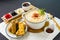 Fish Crispy Roll Fish Udon in Rich Fish Soup noodle with chili sauce and chopsticks served in bowl isolated on napkin side view of