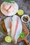 Fish fillet on wooden board with ingredients for cooking, meat dolly fish tilapia striped catfish, fresh raw pangasius fish fillet