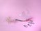 Fish hook with marine litter on pink background. plastic bag. pollution concept