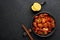 Fish Manchurian dry looks like Schezwan Fish in black bowl at dark slate background