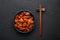 Fish Manchurian dry looks like Schezwan Fish in black bowl at dark slate background