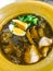 Fish maw soup with meat, egg and vegetable in earthen bowl Braised Fish Maw in red gravy, Asian Thai Chinese street food