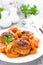Fish meatballs or noisettes baked with carrot, onion and tomato sauce. Fish meatballs on plate