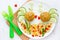 Fish meatballs with porridge and vegetable slices for funny and healthy dinner for kids