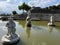 Fish pond in the park and three stone sculpture