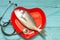 Fish on red heart plate and stethoscope