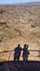 Fish River Canyon panorama with gigantic ravine and shadows of photographer and partner in the foreground