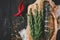 Fish with rosemary on parchment paper on a black wooden background, healthy food on kitchen table top view, grill seafood